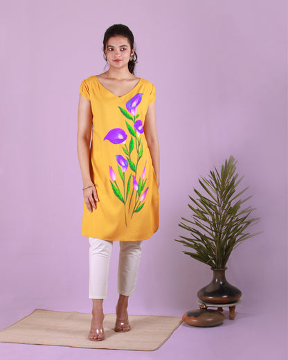 Front view of yellow Calla Lily Tunic in cotton blend with slight puff cap sleeves and drawstring detail