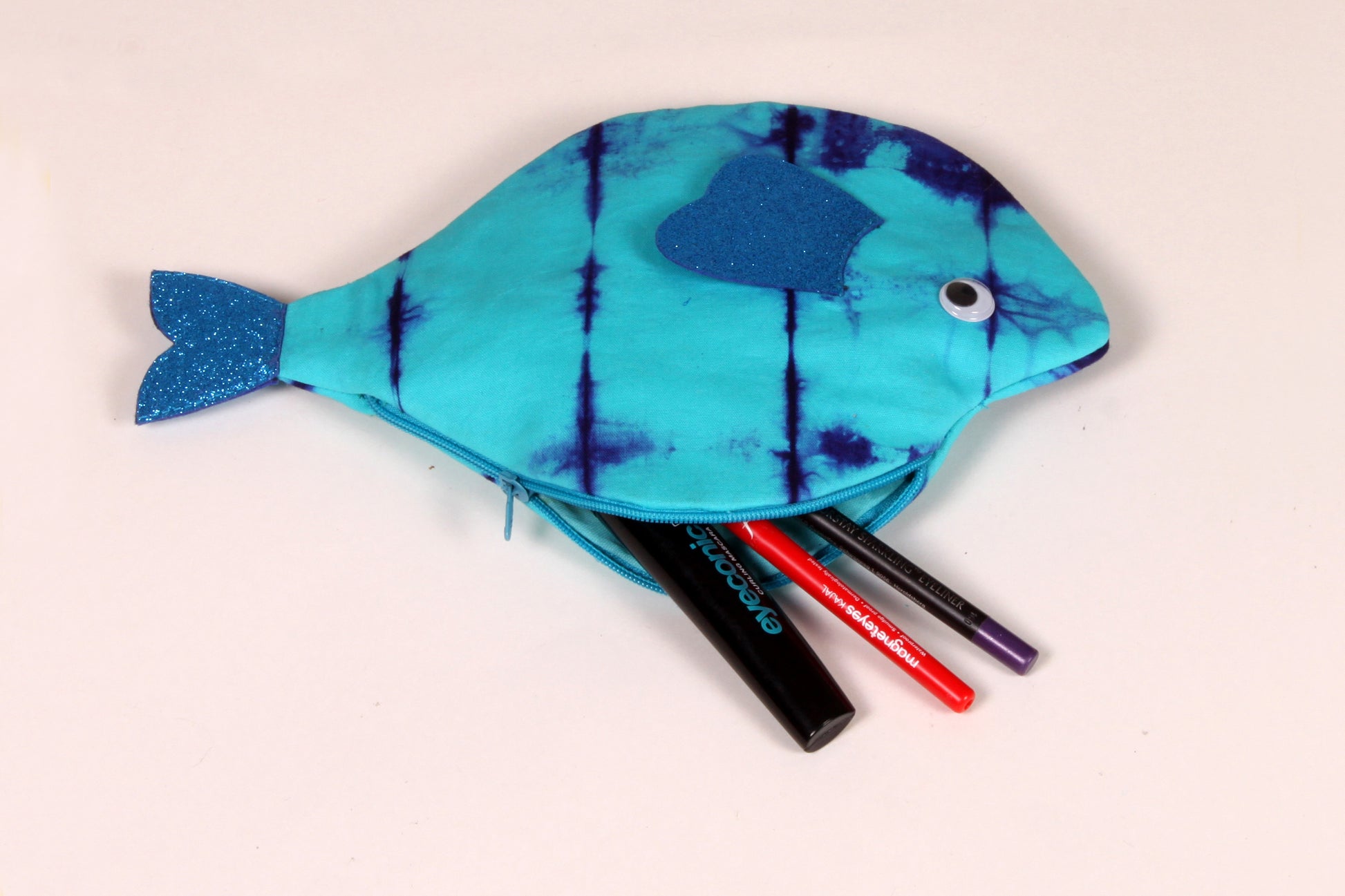 Side view of Blue Pomfret Fish Pouch made from cotton fabric showing makeup organised 