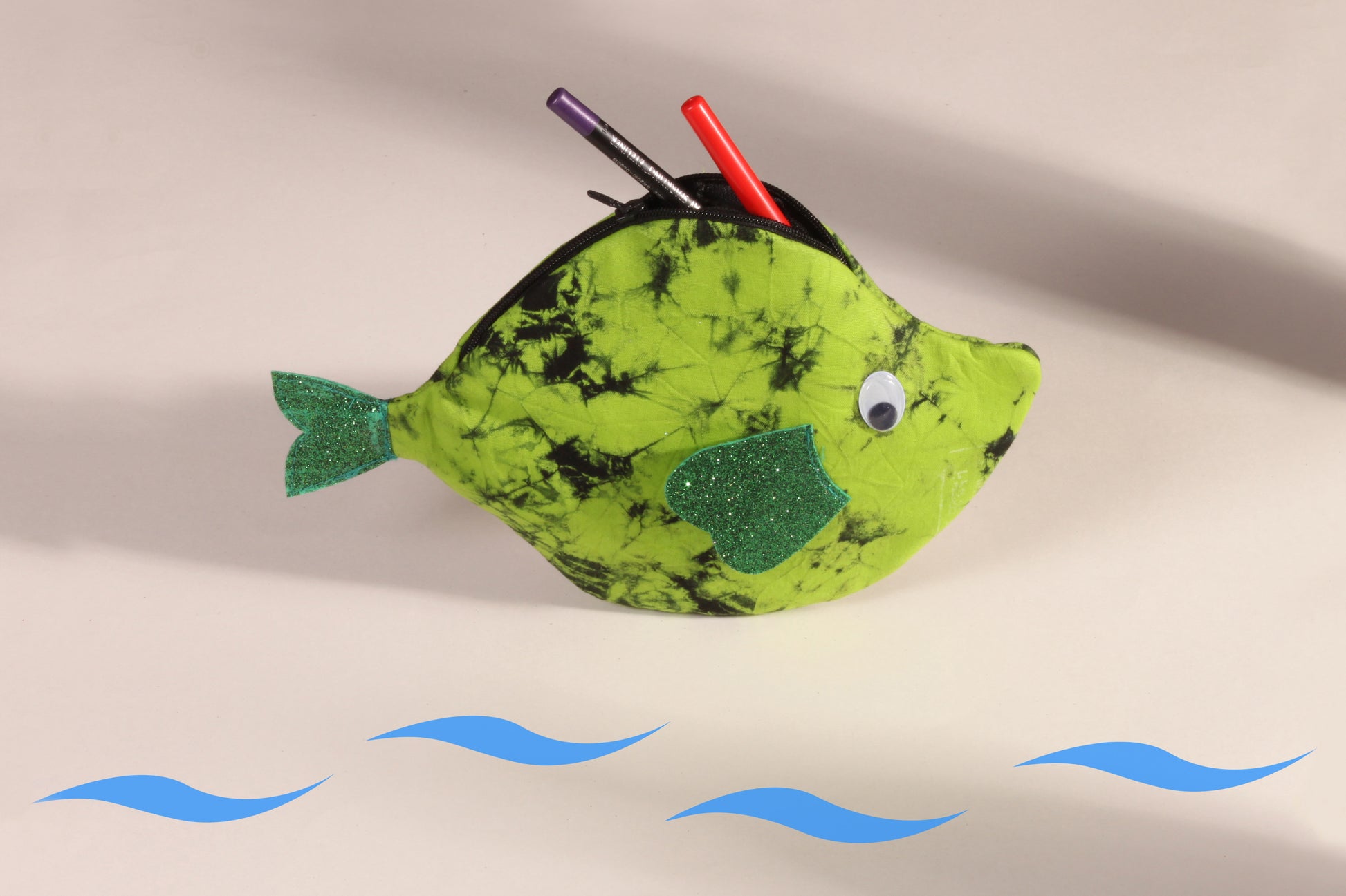 Side view of Green Pomfret Fish Pouch made from cotton fabric showing makeup organised 