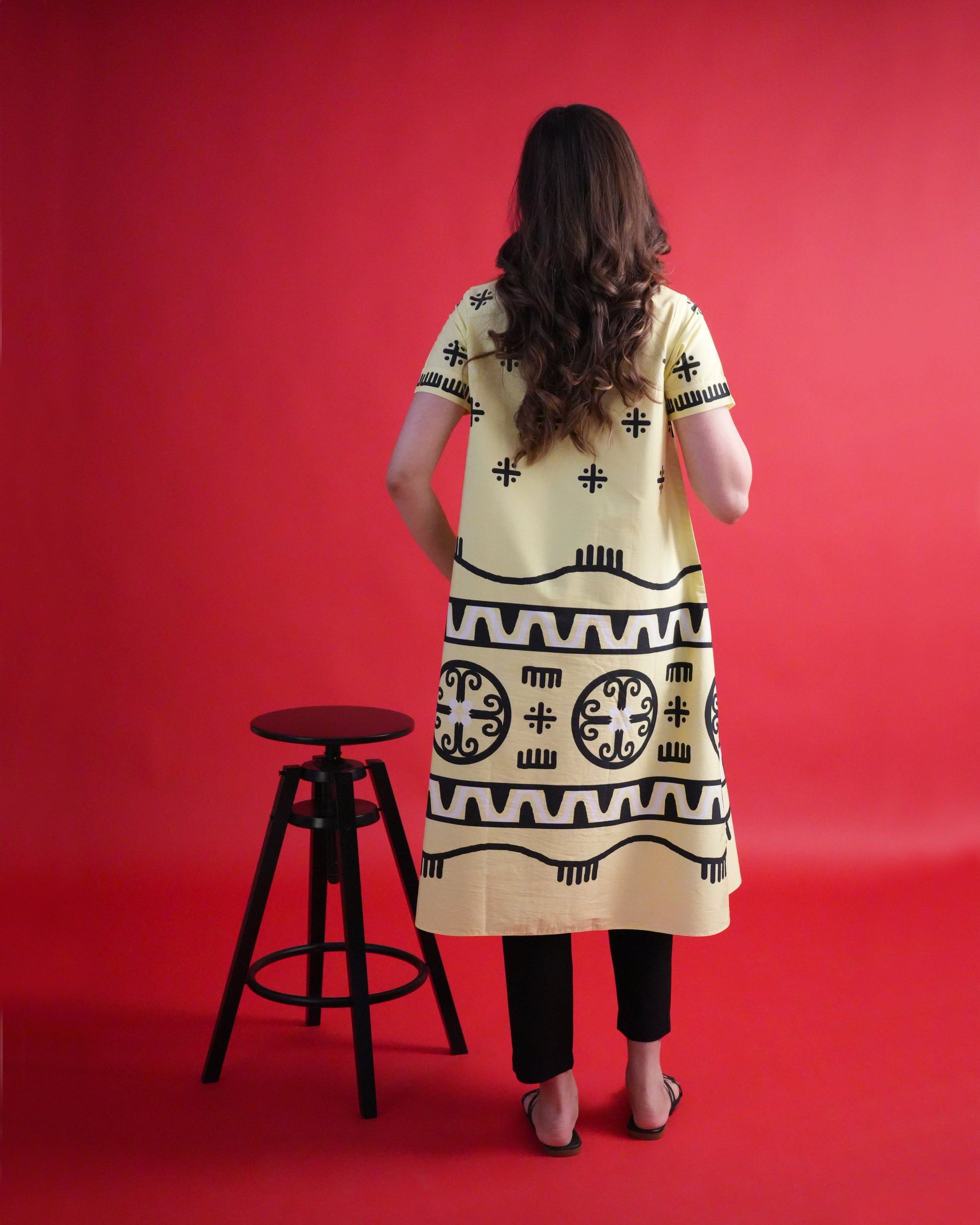 Back view of the Kiiro Cotton Co-ord Set showing the pastel yellow wrap kurta design with black narrow-leg trousers