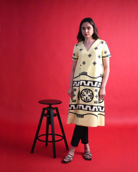 Front view of the Kiiro Cotton Kurta Co-ord Set in pastel lemon yellow with tribal printed wrap kurta and black bottoms