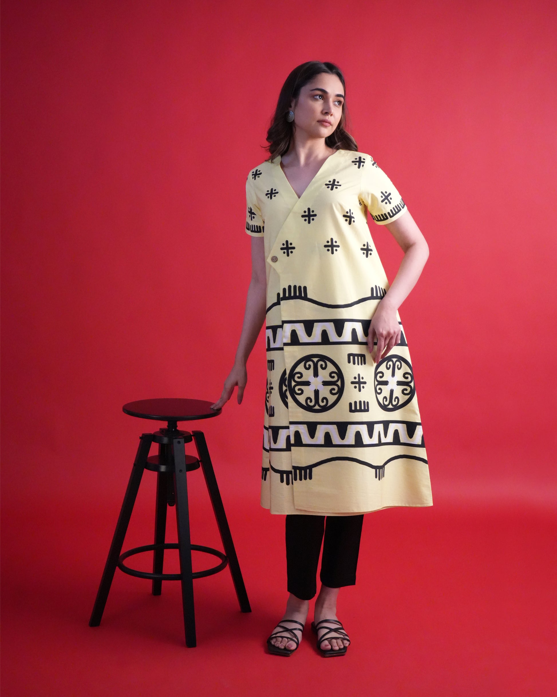 Model wearing the Kiiro Cotton Kurta Co-ord Set, showcasing the pastel yellow tribal wrap kurta with contrasting black pants
