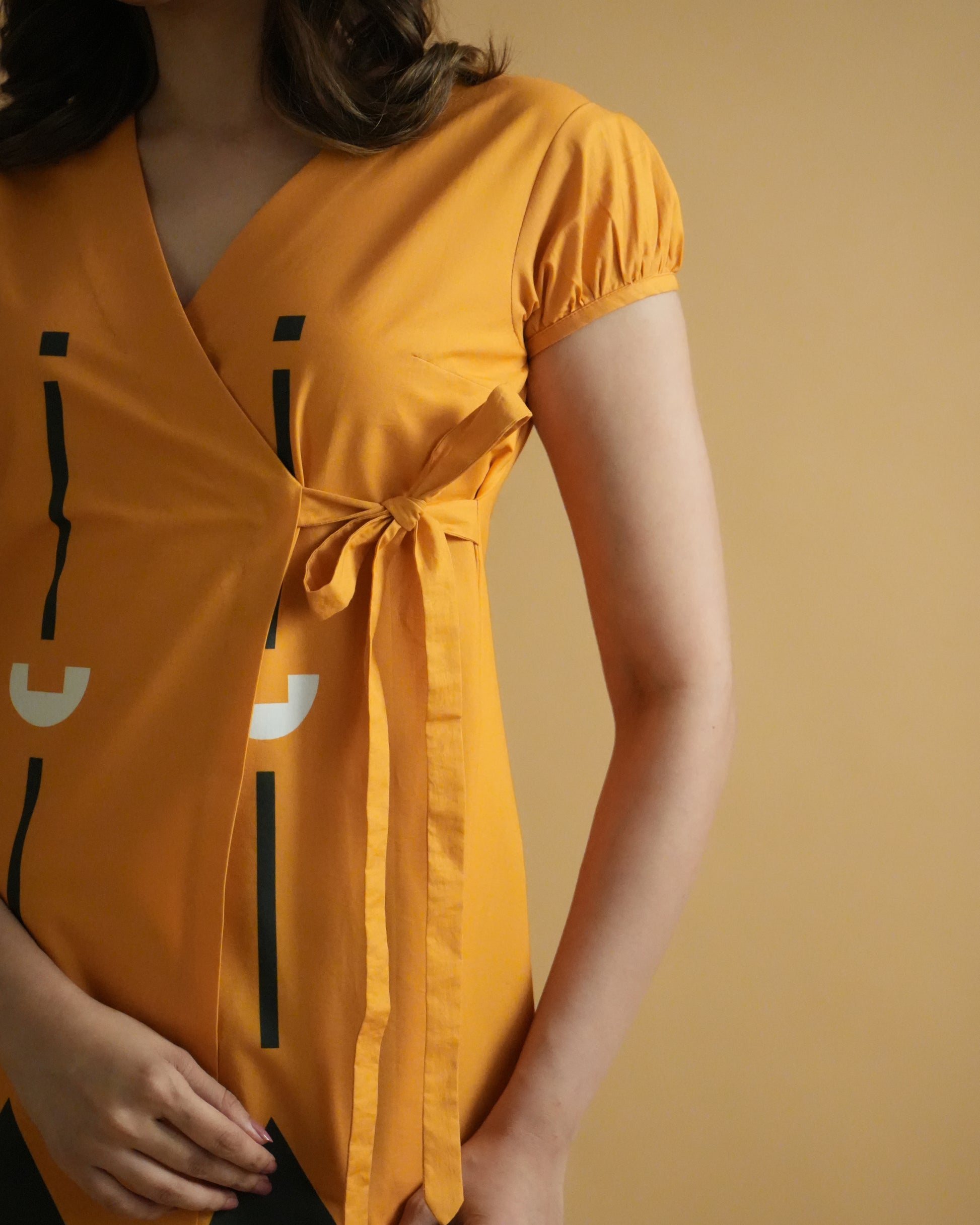 Close-up of wrap detail and tribal prints on orange kurta from the Kara Cotton Co-ord Set.