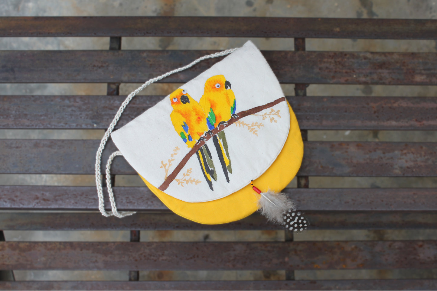 Front flap view of handpainted Sun Conure Sling Bag made from cotton fabric