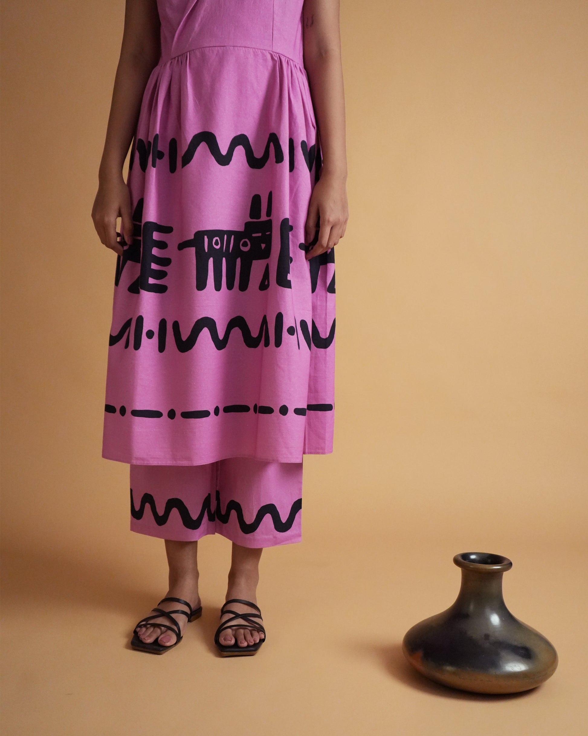 Fabric close-up showing pink cotton with tribal-inspired motifs from the Jambu Cotton Co-ord Set
