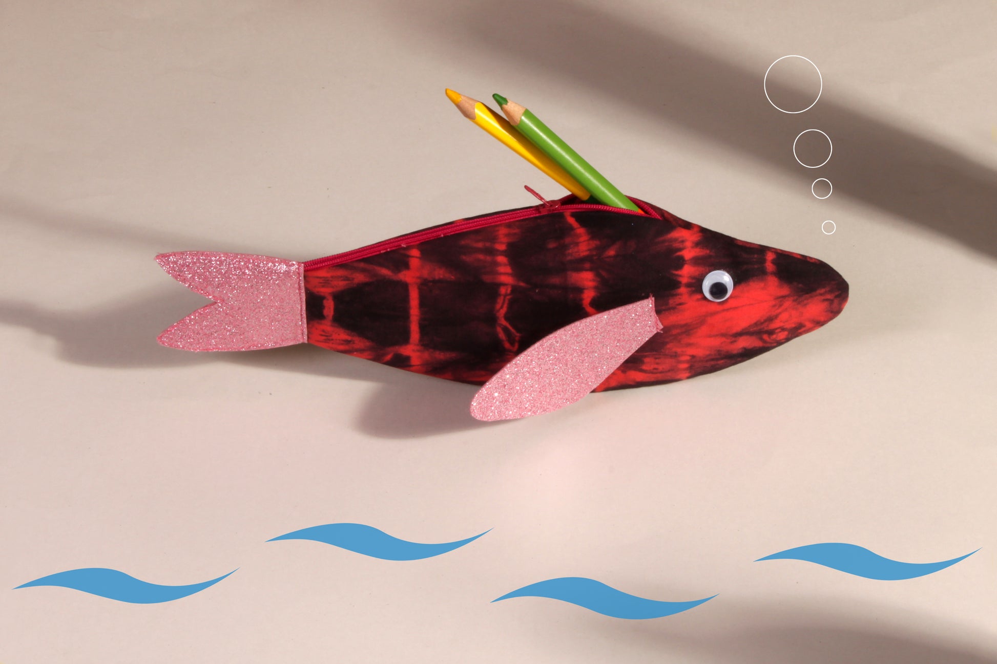 Side view of Pink Rohu Fish Pouch made from cotton fabric showing stationery organised 