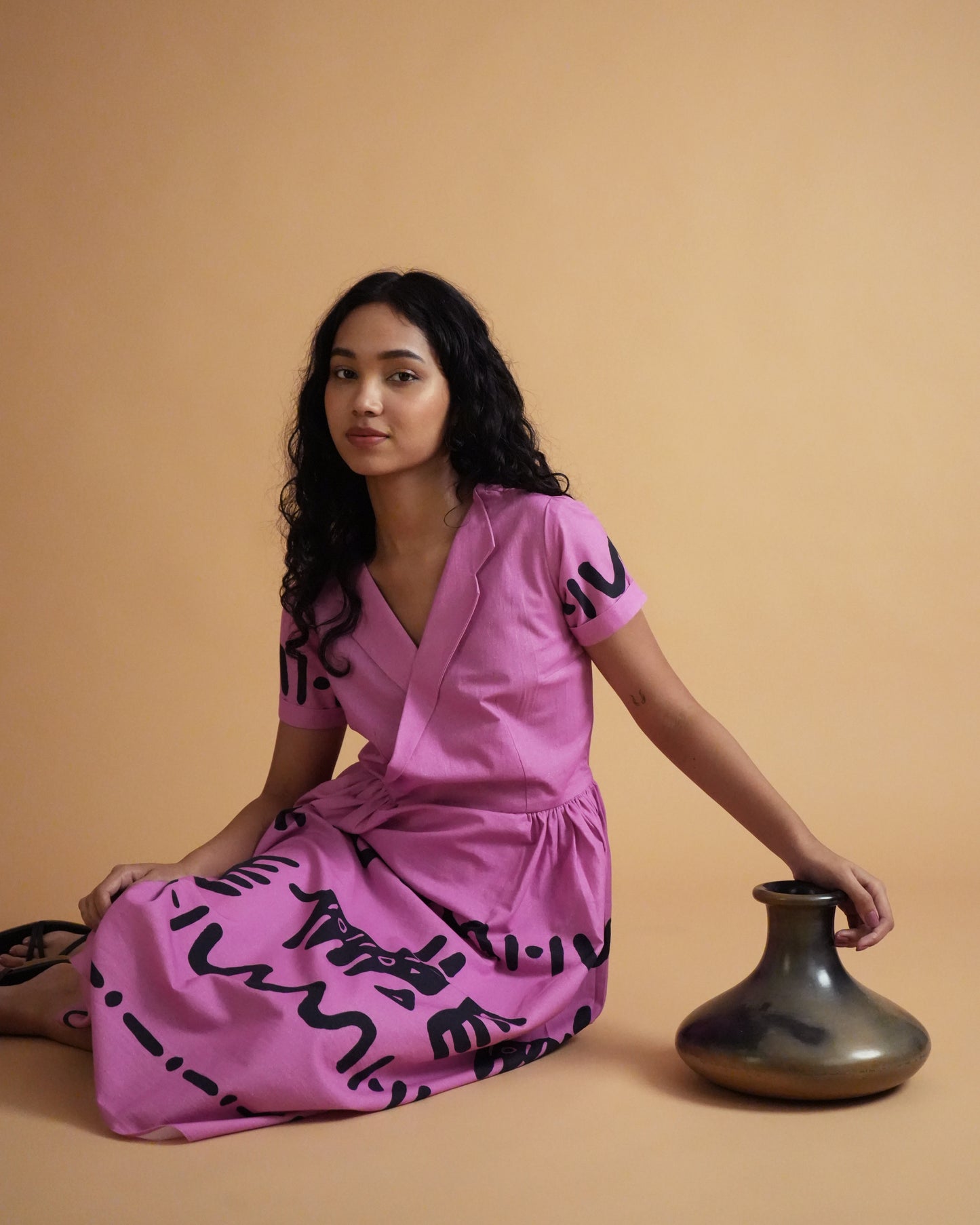 Side view of Jambu Cotton Co-ord Set in pink with tribal motifs, lapel-collar kurta, and wide-leg pants