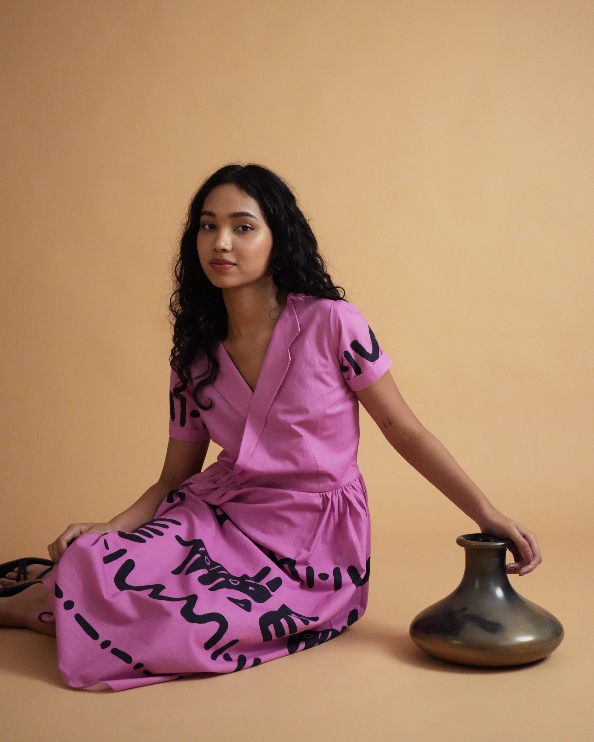Side view of Jambu Cotton Co-ord Set in pink with tribal motifs, lapel-collar kurta, and wide-leg pants