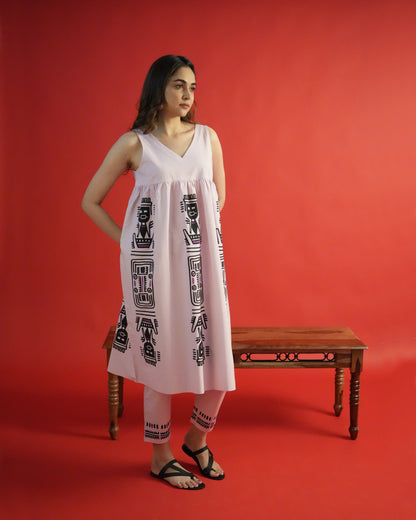 Side view of Merah Cotton Co-ord Set in powder pink with tribal motifs and sleeveless empire-line kurta.