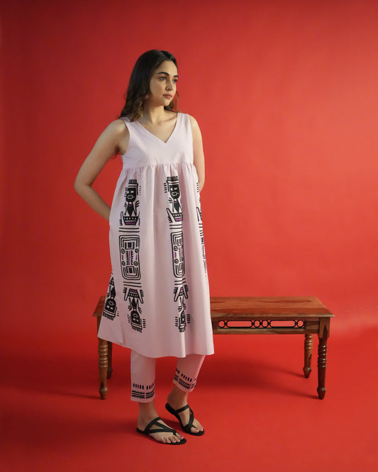 Side view of Merah Cotton Co-ord Set in powder pink with tribal motifs and sleeveless empire-line kurta.