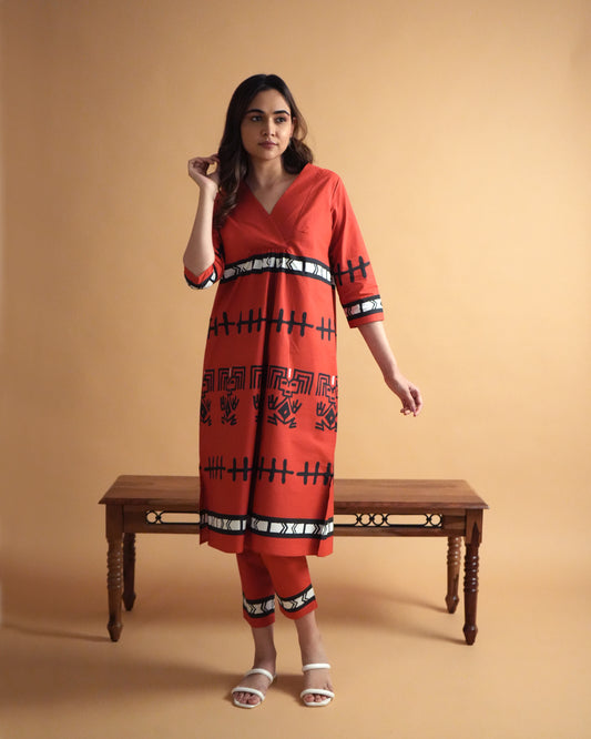 Front view of Puka Cotton Co-ord Set in vibrant red with overlapped neckline, tribal prints, side slits, and slim pants