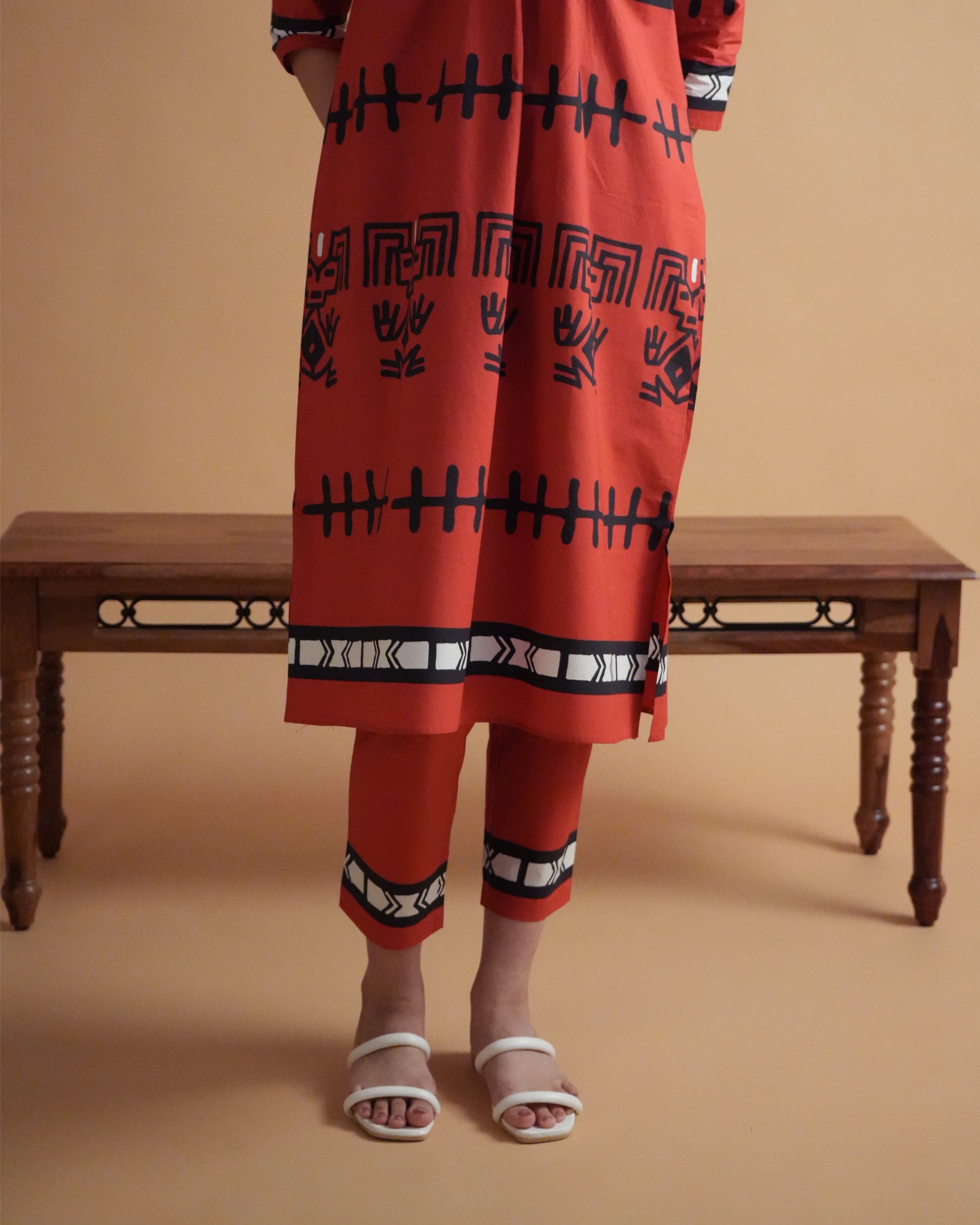 Fabric close-up showing vibrant red cotton with tribal-inspired prints from the Puka Co-ord Set