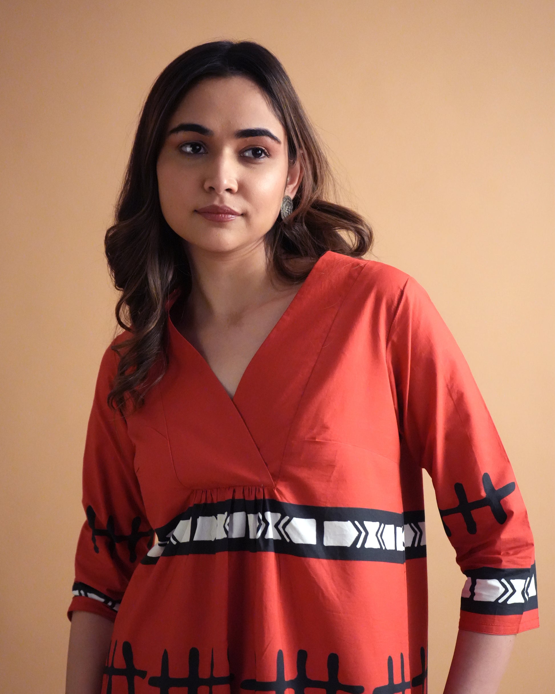 Close-up of tribal motifs and overlapped neckline on the vibrant red Puka Cotton Kurta Co-ord Set