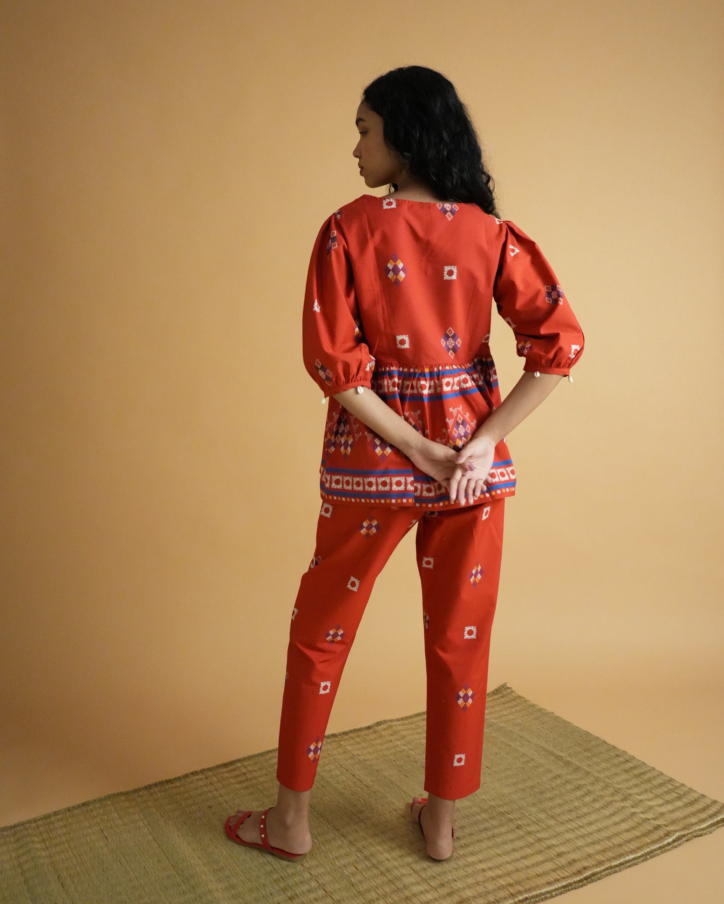 Back view of Ula Cotton Kurta Co-ord Set in red cotton showing gathered waistline and slim pants
