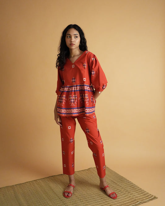Front view of Ula Cotton Co-ord Set in striking red with gathered waistline kurta, shell-detailed puff sleeves, and slim pants.