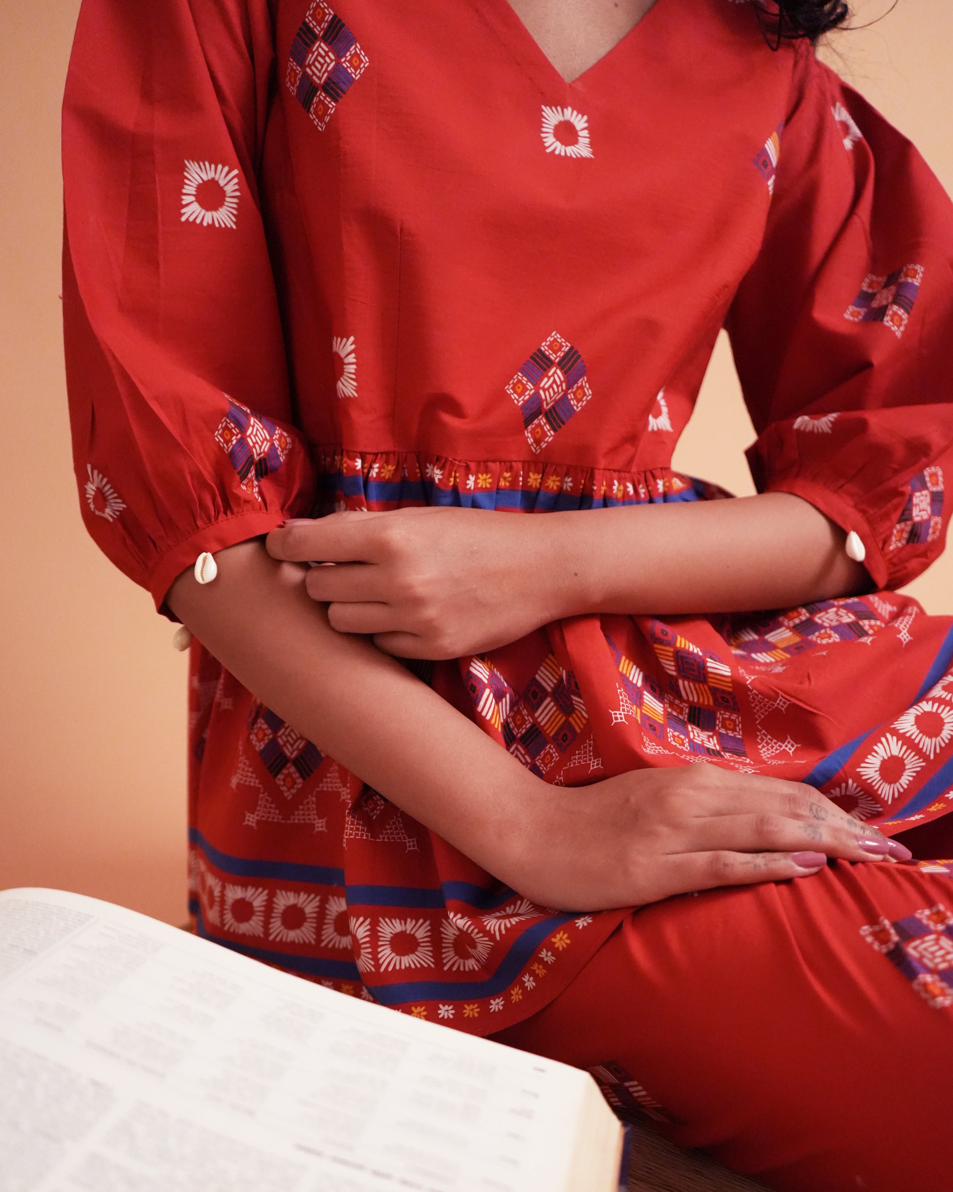Detailed shot of shell-detailed puff sleeve in red cotton from the Ula Cotton Kurta Co-ord Set