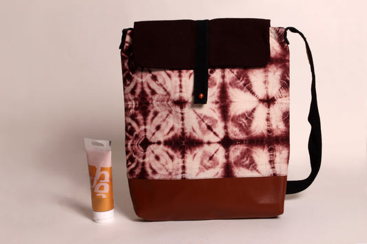 Front view of Brown Ripple Artist Bag made from cotton fabric with faux leather, a magnetic snap closure, and a pocket 