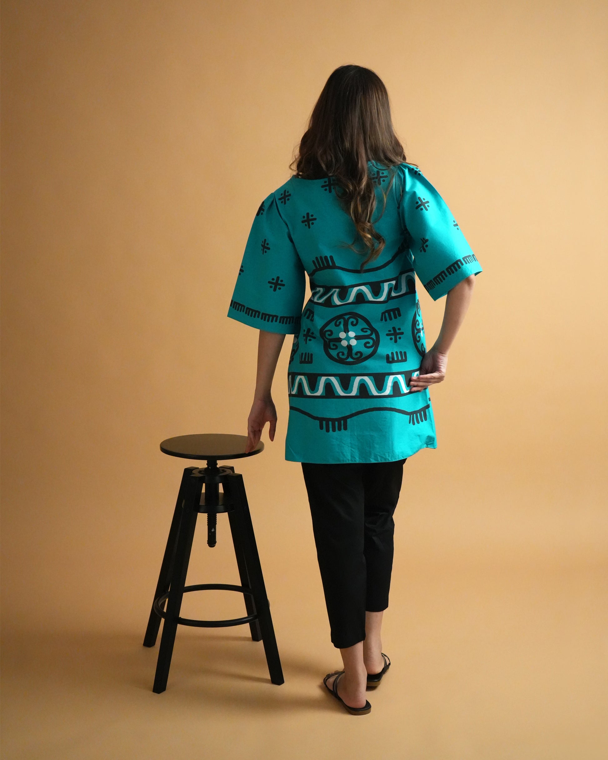 Back view of Biru Cotton Kurta Co-ord Set in turquoise cotton showing wrap design and slim pants