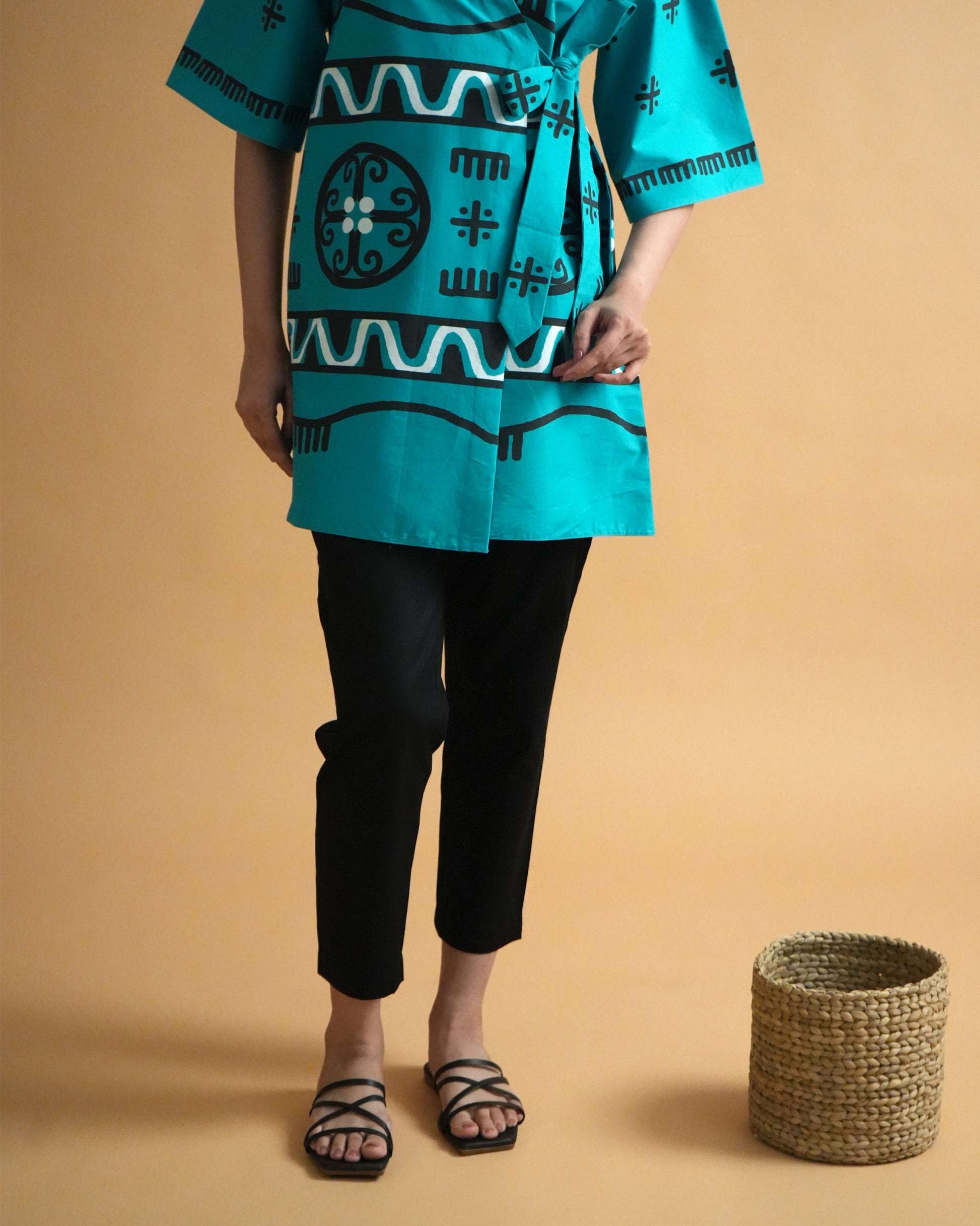 Fabric close-up of turquoise cotton with tribal-inspired wrap detail from the Biru Cotton Co-ord Set