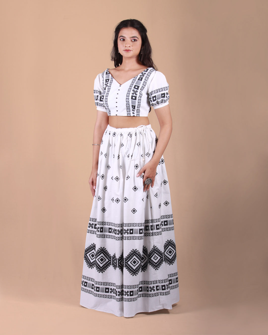 Front view of Ivory Tribal Co-ord Set with a cotton crop top and skirt in tribal print, puff sleeves, and tassel accents