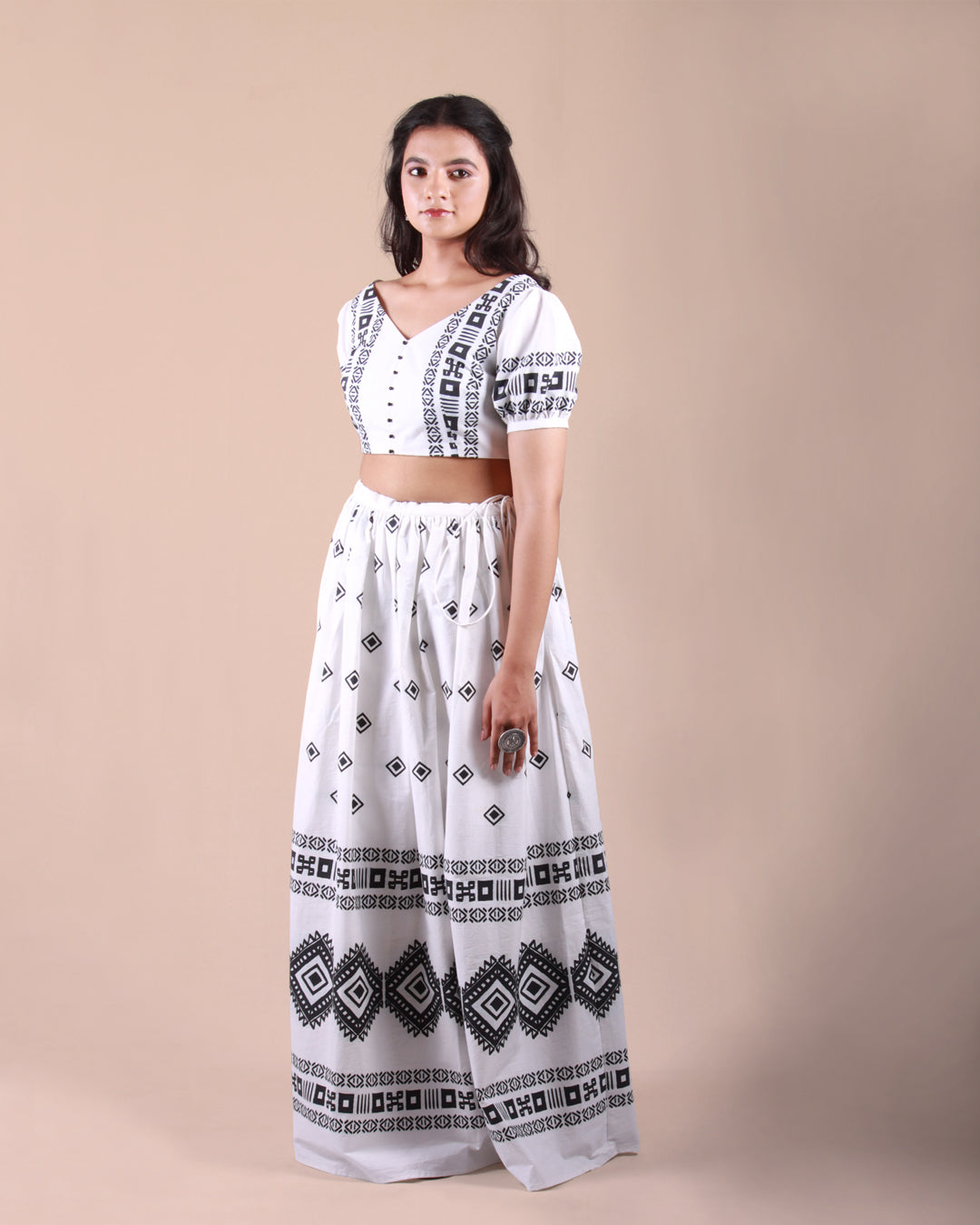 Ivory Tribal Co-ord Set for women with a cotton crop top and skirt in tribal print, puff sleeves, and tassel accents