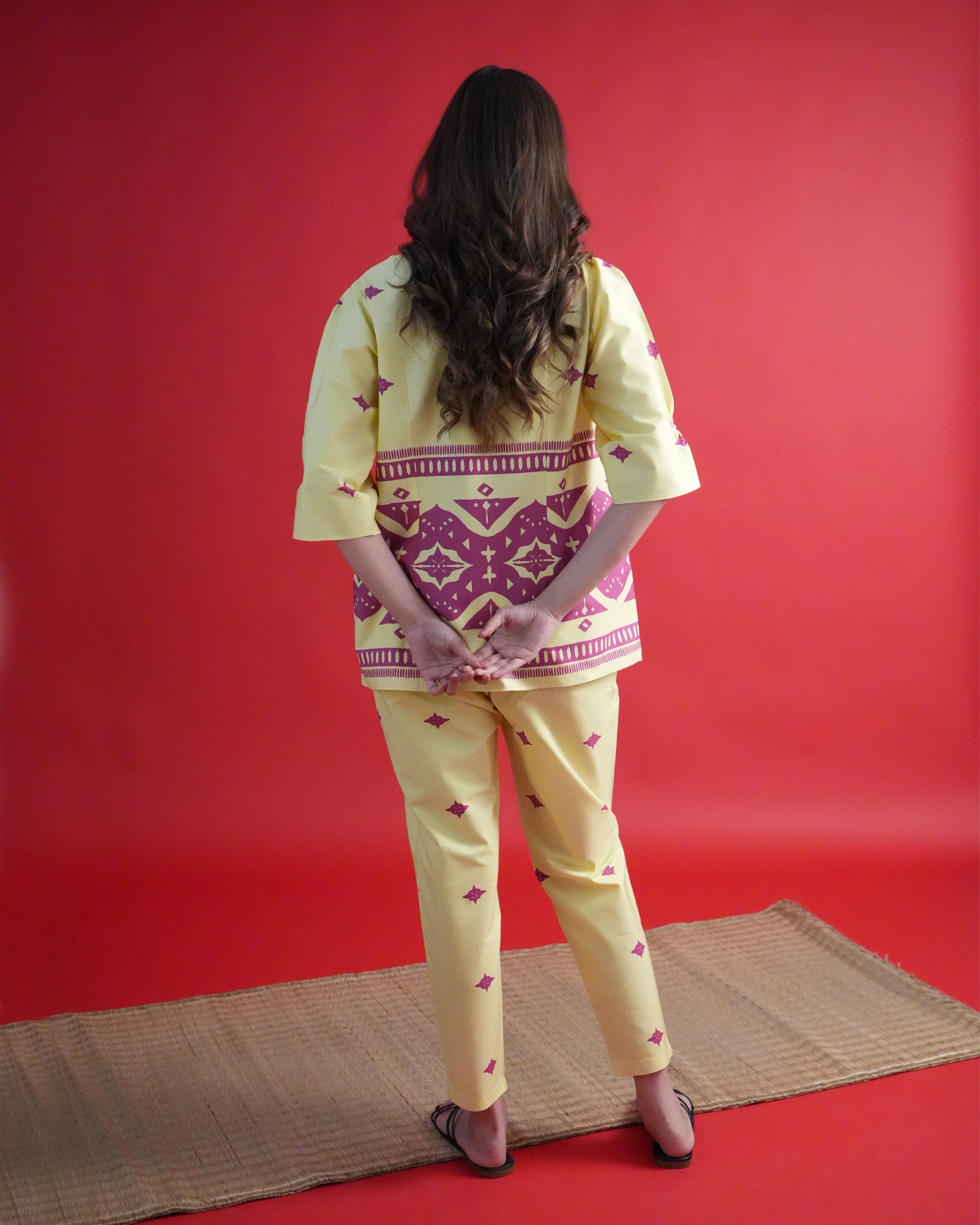 Back view of Yona Cotton Kurta Co-ord Set in lemon yellow showing tribal motifs and straight-fit pants