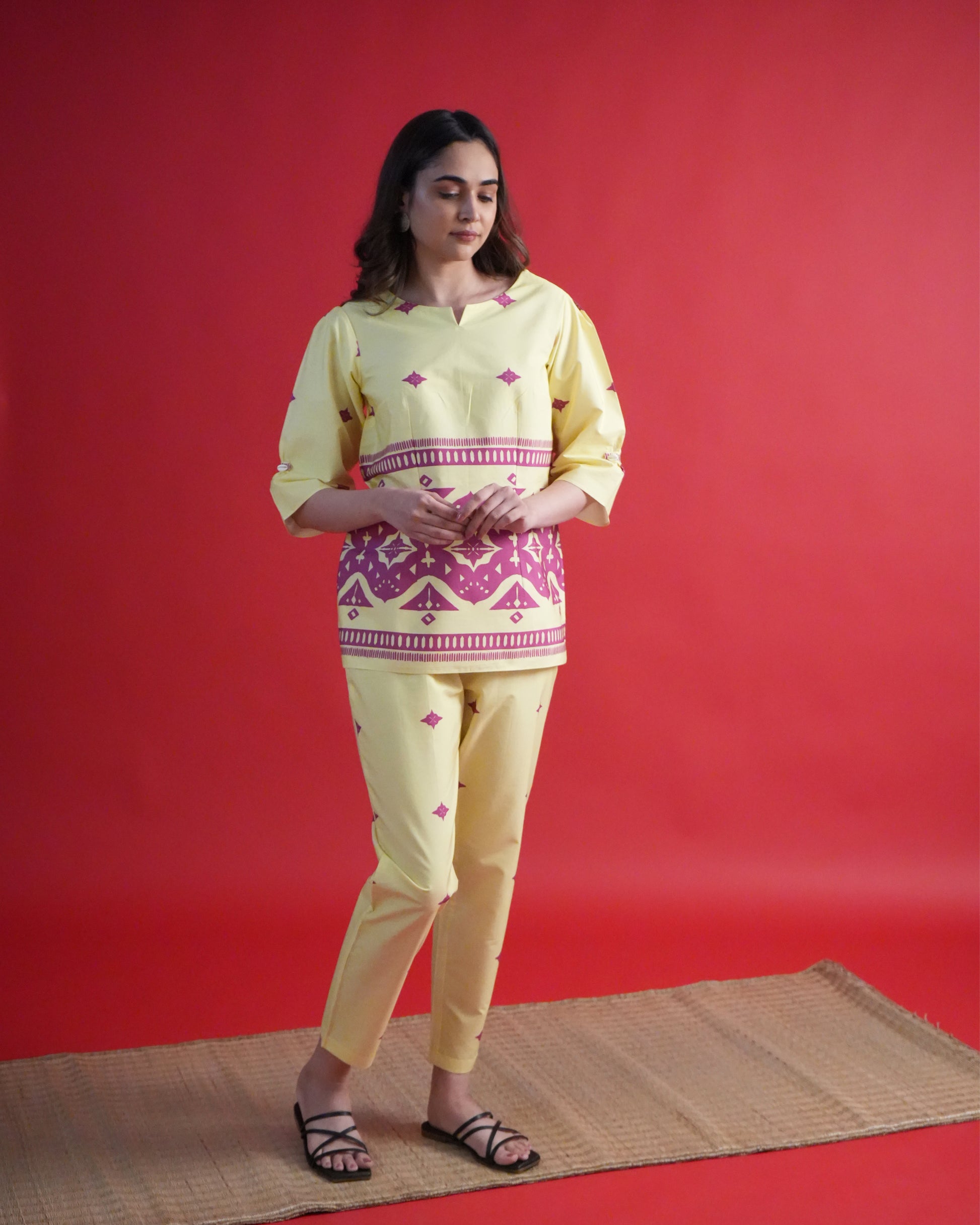 Side view of lemon yellow Yona Cotton Co-ord Set with shell loop sleeves and tribal prints